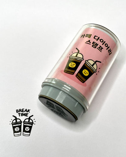Black stamp representing two take-away juice cups with the words 'Break Time'. the self inking stamp bottled in laying next to it with a pink label and the picture of the stamp.
